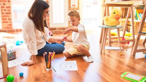blog-Ultimate Guide To At-Home Learning Activities For Toddlers_feature Mom engaging in learning activities for toddler at home sitting on the floor